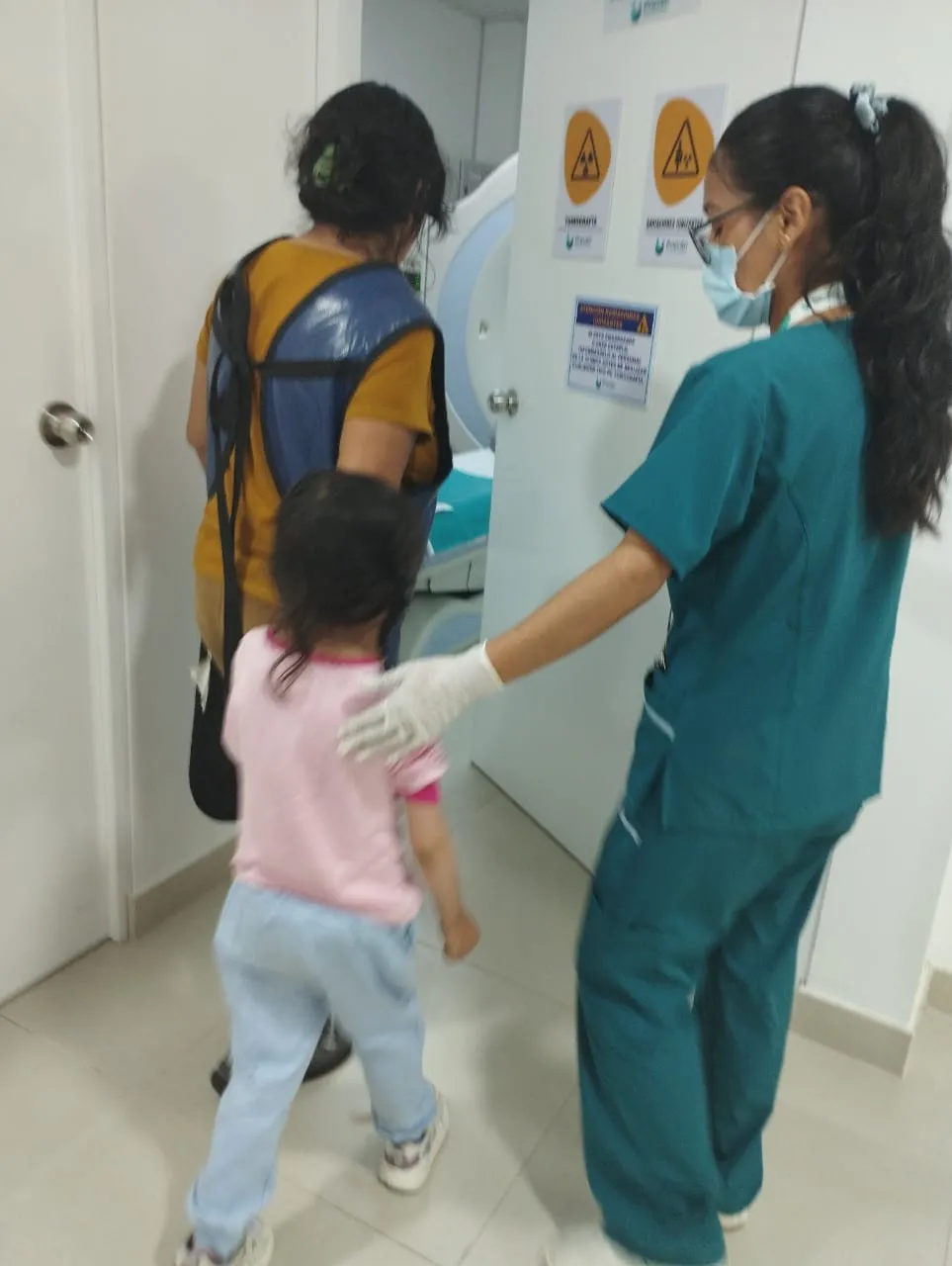 Haviv being walked into an imaging room by a nurse