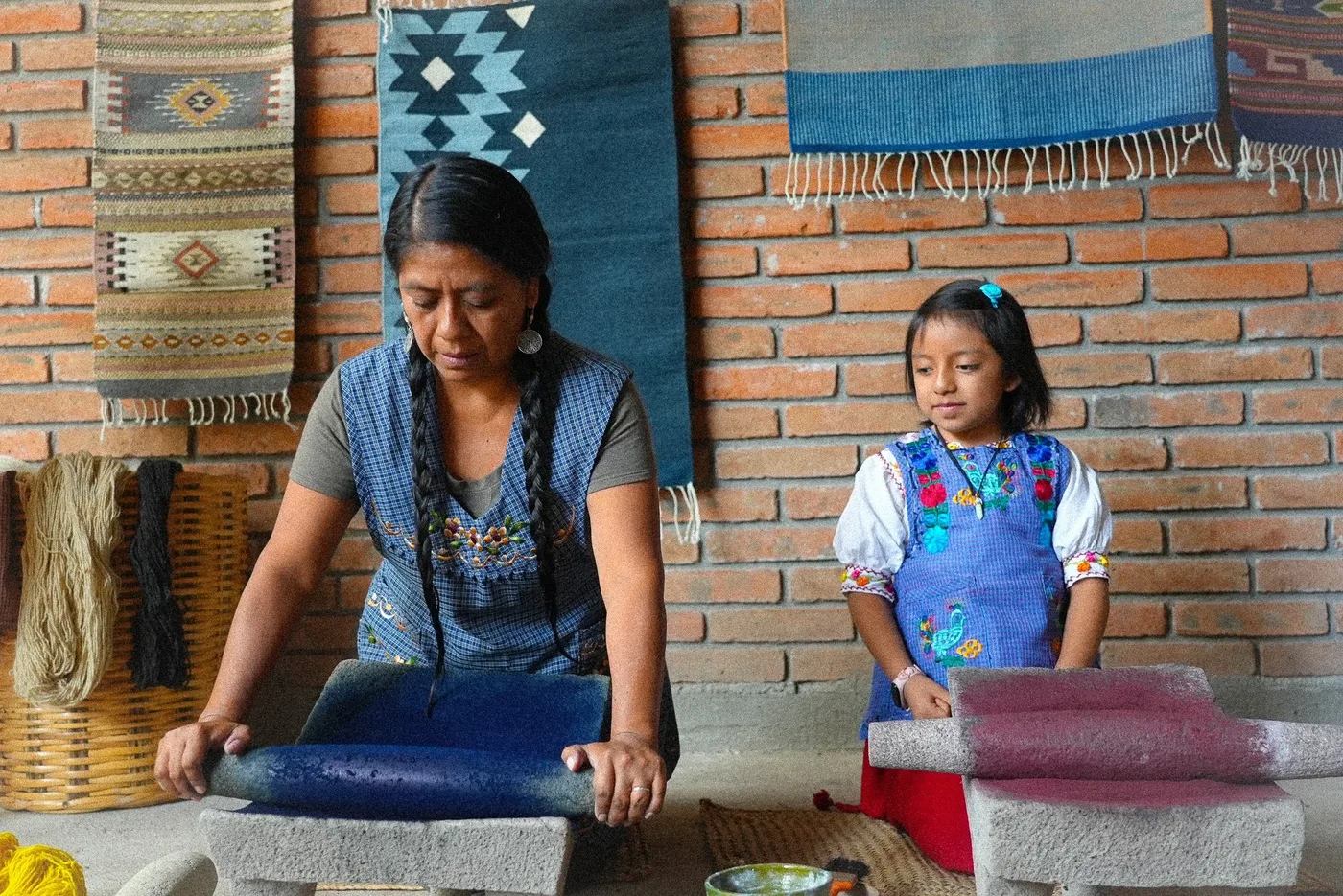 Grinding natural dye on a stone metate in Teotitl&aacute;n del Valle