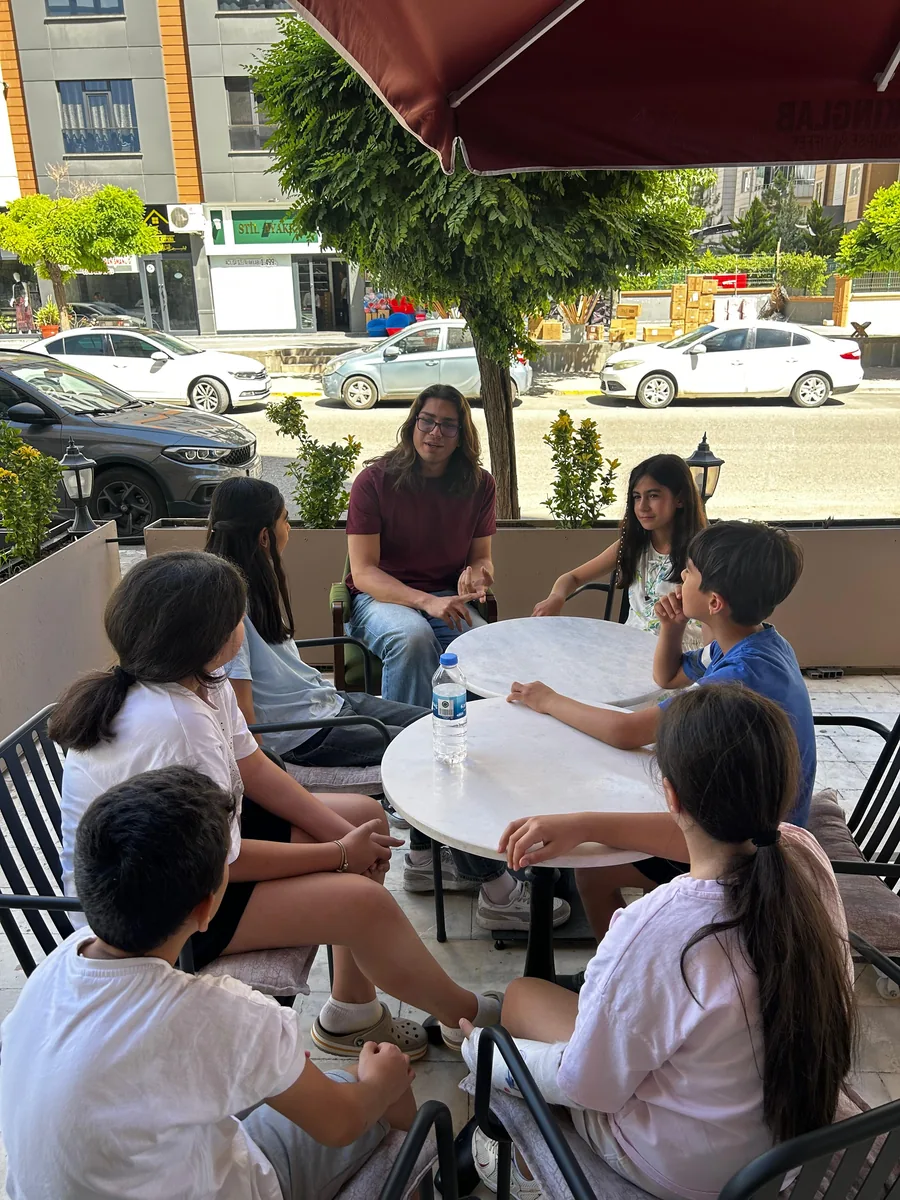 A SpeakingLab teacher talking with students outside the school