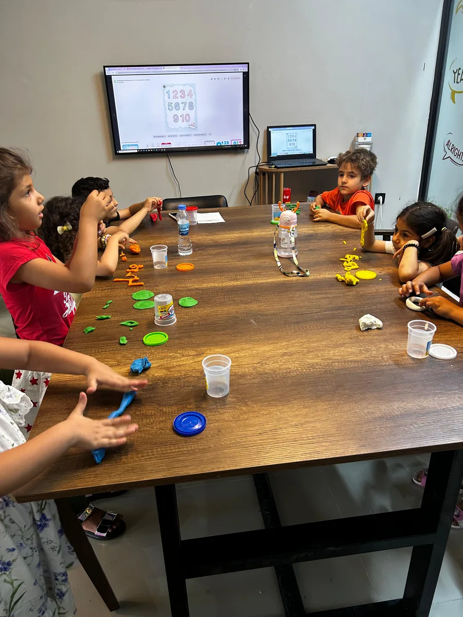 Young students learning numbers with a hands-on activity at SpeakingLab