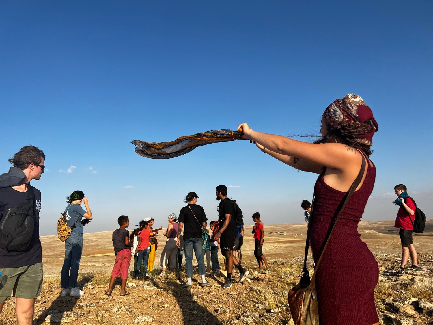Travelers outside in a high desert landscape